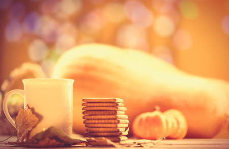 Cup of coffee or tea with cookies on autumn backgroundの写真素材