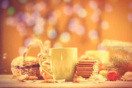 Cup of coffee or tea with cookies on autumn backgroundの写真素材