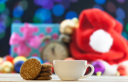 Cup of tea or coffee and cookies on Christmas background