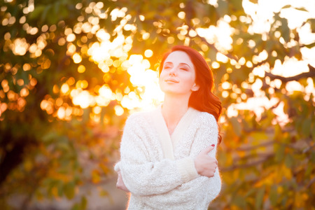 Woman in white blazer in autumn time outdoorの写真素材