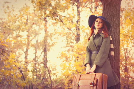woman with bag at countryside in autumn timeの写真素材