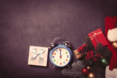 Alarm clock and gifts with baubles on grey background.の写真素材