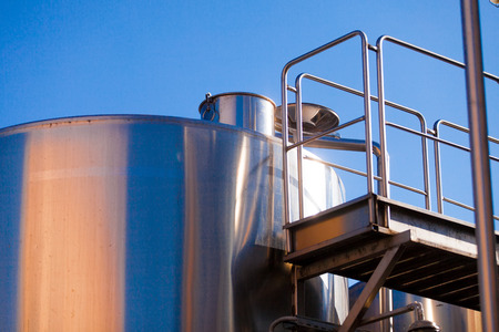 Metal capacity for wine on blue sky backgroundの写真素材