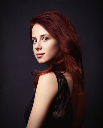 Portrait of a beautiful woman in style dress on dark backgorundの写真素材