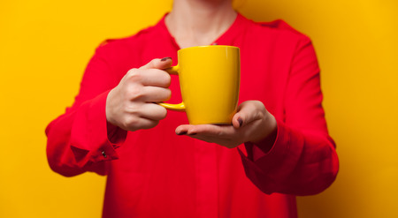 Young caucasian woman holding a cupの写真素材