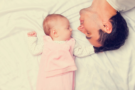 Father and little baby in the bad