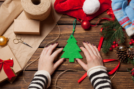 Woman and christmas tree toy before wrapping. High point of viewの写真素材