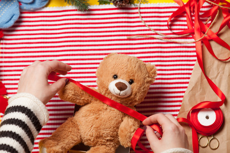 Woman have wrapping a teddy bear toy. High point of viewの写真素材