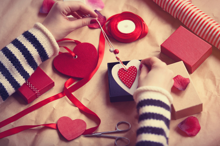 Woman preparing gift for wrapping for Valentine's Dayの写真素材