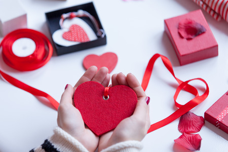 Woman preparing gift for wrapping for Valentine's Dayの写真素材