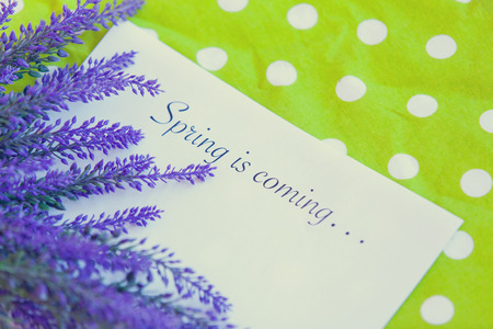 Paper with words Spring in coming and flower on a napkinの写真素材