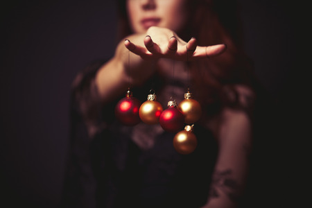 woman holding christmas decorations in her handの写真素材