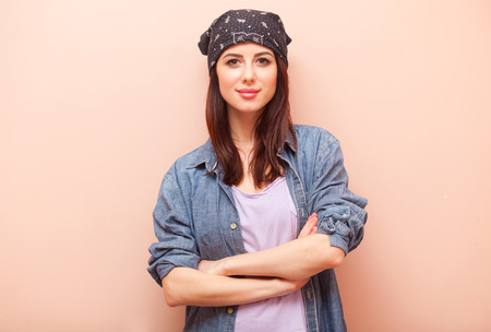 portrait of beautiful young woman standing on the pink backgroundの写真素材
