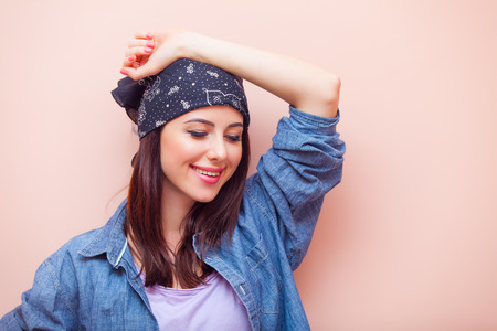 portrait of beautiful young woman standing on the pink backgroundの写真素材