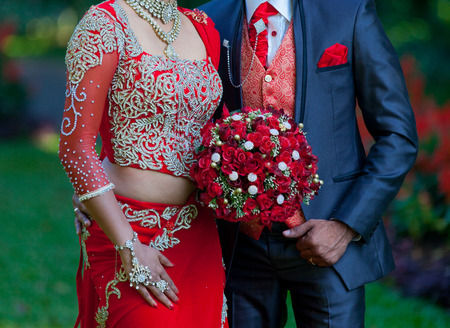 photo of the wedding couple standing on the green backgroundの写真素材
