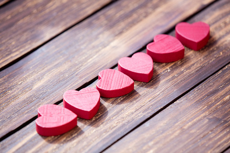 red wooden  hearts on the brown wooden tableの写真素材