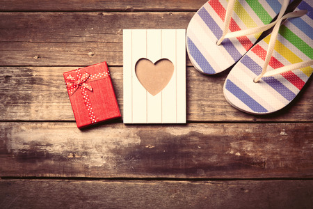colorful sandals, postcard and gift  on the brown wooden backgroundの写真素材