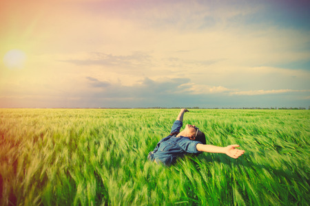 portrait of the beautiful young woman standing in the fieldの写真素材