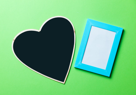black board and photo frame on the green backgroundの写真素材