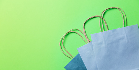 blue shopping bags on the green backgroundの写真素材