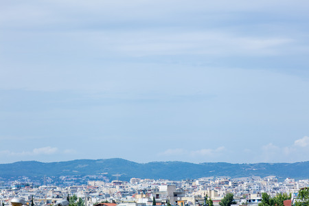 photo of the beautiful modern city in the Greece on the mountain backgroundの写真素材