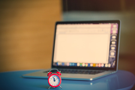 photo of the working place with notebook and little alarm clock