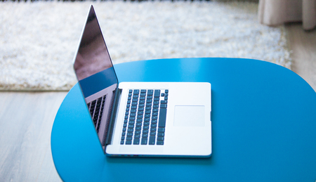 photo of the working place with Notebook and a blue table
