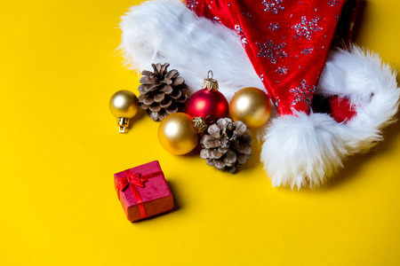 photo of the beautiful Christmas decorations and gift on the yellow backgroundの写真素材