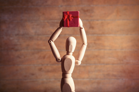 photo of the beautiful gestalta with gift on the brown wooden backgroundの写真素材