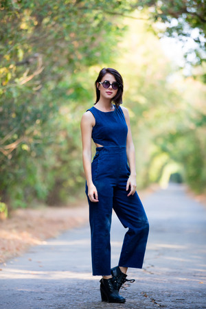 portrait of the beautiful young woman standing in the middle of the roadの写真素材