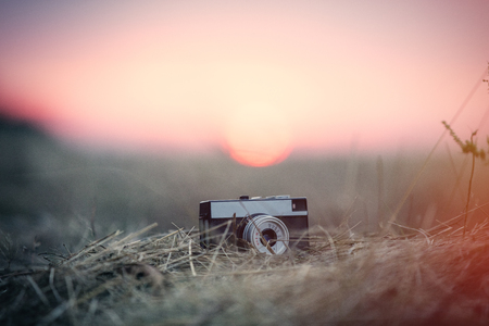 Vintage camera on the ground in sunset timeの写真素材