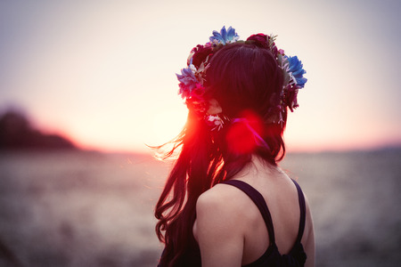 Portrait of a beautiful brunette woman with wreath in autumn outdoorの写真素材