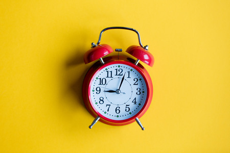 christmas alarm clock on yellow backgroundの写真素材