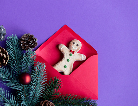 Red christmas envelope and gifts on violet backgroundの写真素材