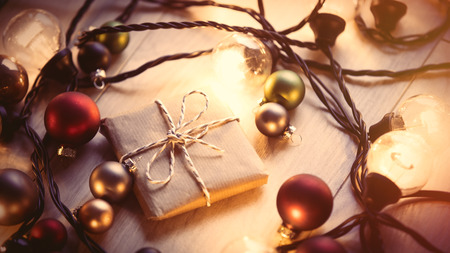 Christmas gift and fairy lights around it 