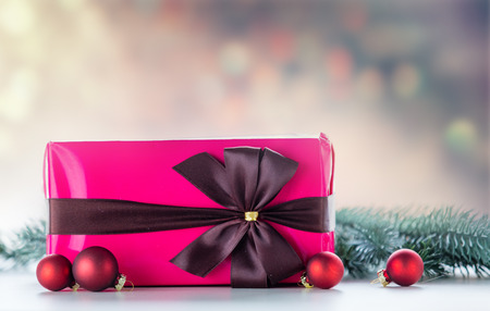 Christmas gift and baubles with pine branch on dark backgroundの写真素材