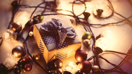 Christmas gift and fairy lights around it 