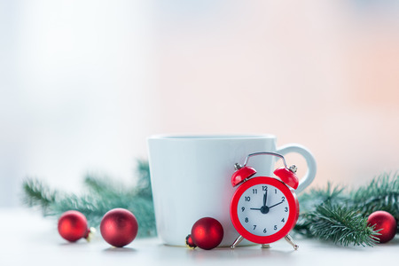 Alarm clock and cup with christmas decoration around