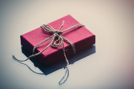 Little gift box on white glass backgroundの写真素材