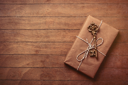 beautiful gift and cute key lying on the wonderful brown wooden backgroundの写真素材