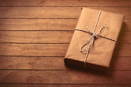 beautiful gift lying on the wonderful brown wooden backgroundの写真素材