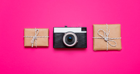 small beautiful gifts and cool camera on the wonderful pink backgroundの写真素材