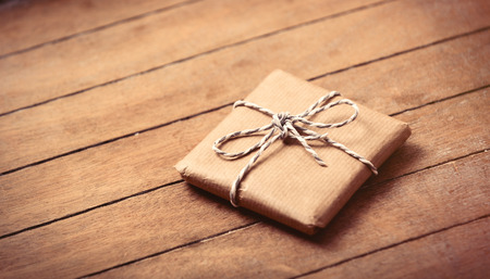 beautiful gift lying on the wonderful brown wooden backgroundの写真素材