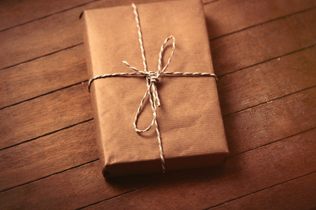 beautiful gift lying on the wonderful brown wooden backgroundの写真素材