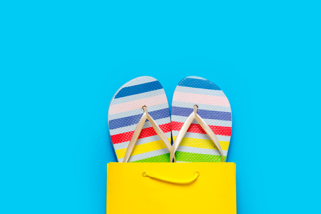 colorful sandals in cool shopping bag on the wonderful blue backgroundの写真素材