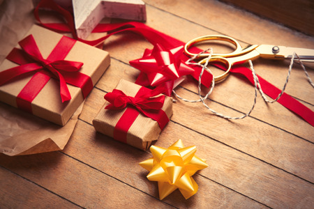 cute gifts, star shaped toy and things for wrapping on the wonderful wooden brown backgroundの写真素材