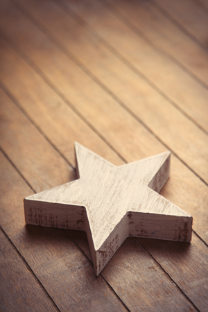 beautiful star shaped toy lying on the wonderful brown wooden backgroundの写真素材