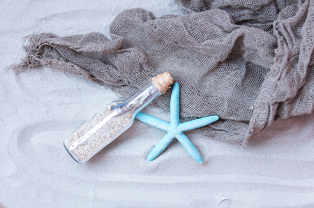 beautiful souvenir, starfish and cool fishnet lying on the wonderful beach sand backgroundの写真素材
