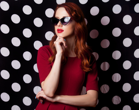 beautiful young woman standing in front of the wonderful dotted backgroundの写真素材