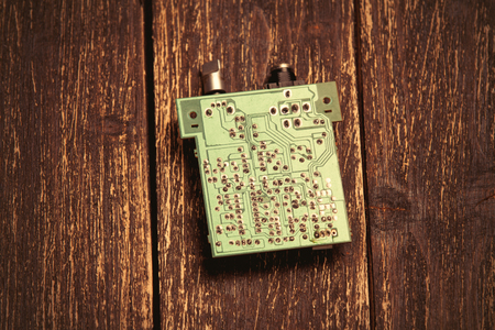 photo of cool small modern microchip on the wooden brown background